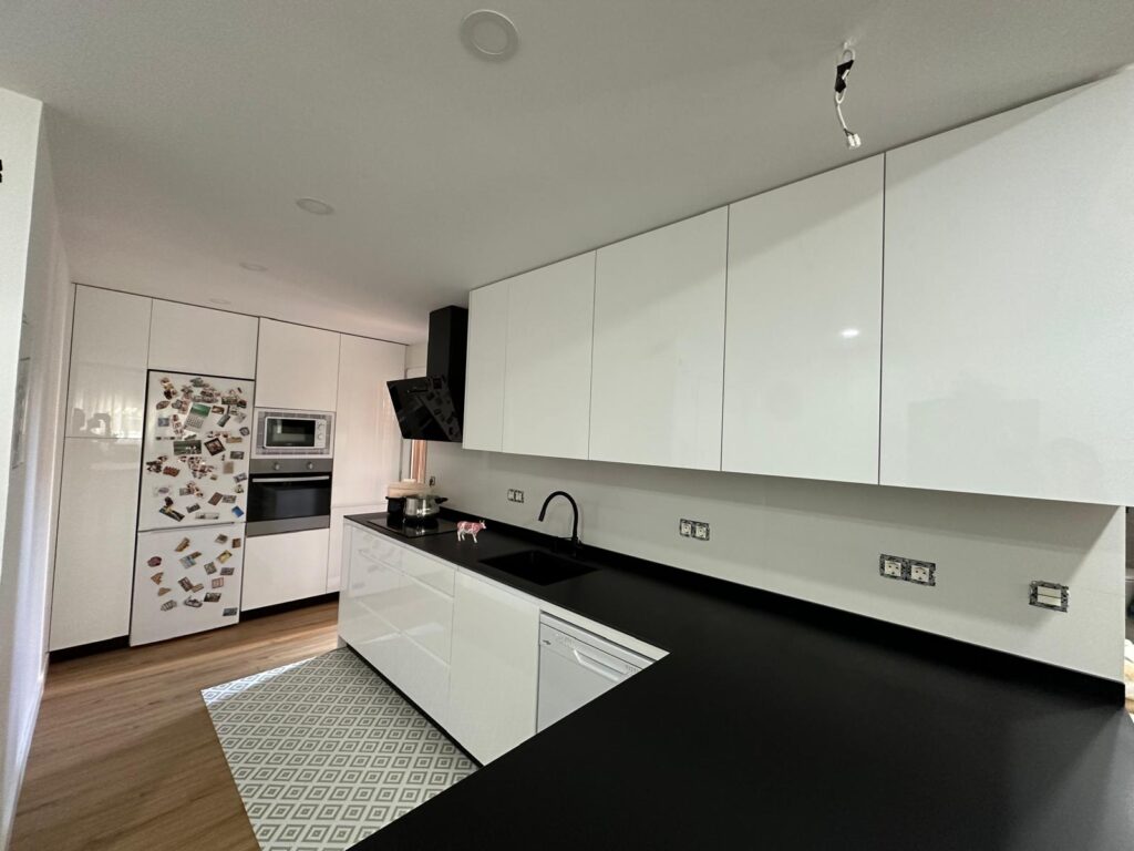 cocina blanca minimalista a medida en Madrid con electrodomésticos de última generación